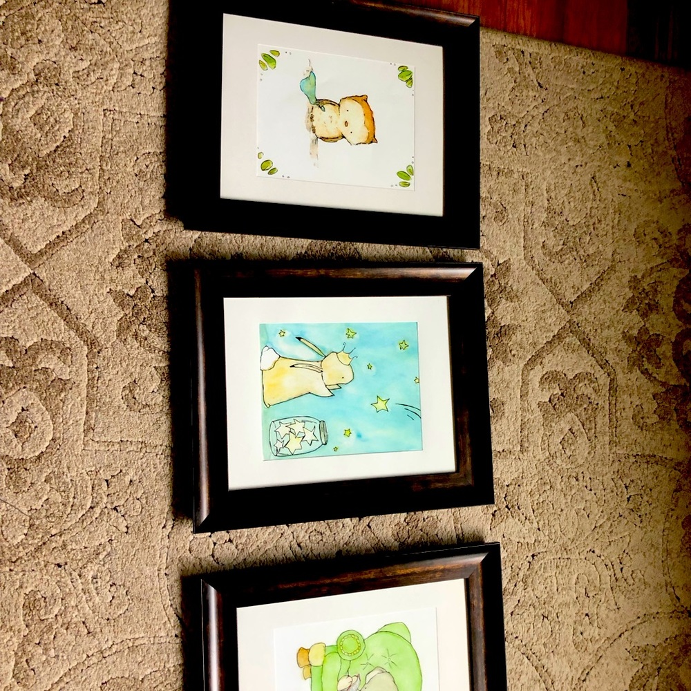 Three framed nursery prints. Frames are brown and 8x10